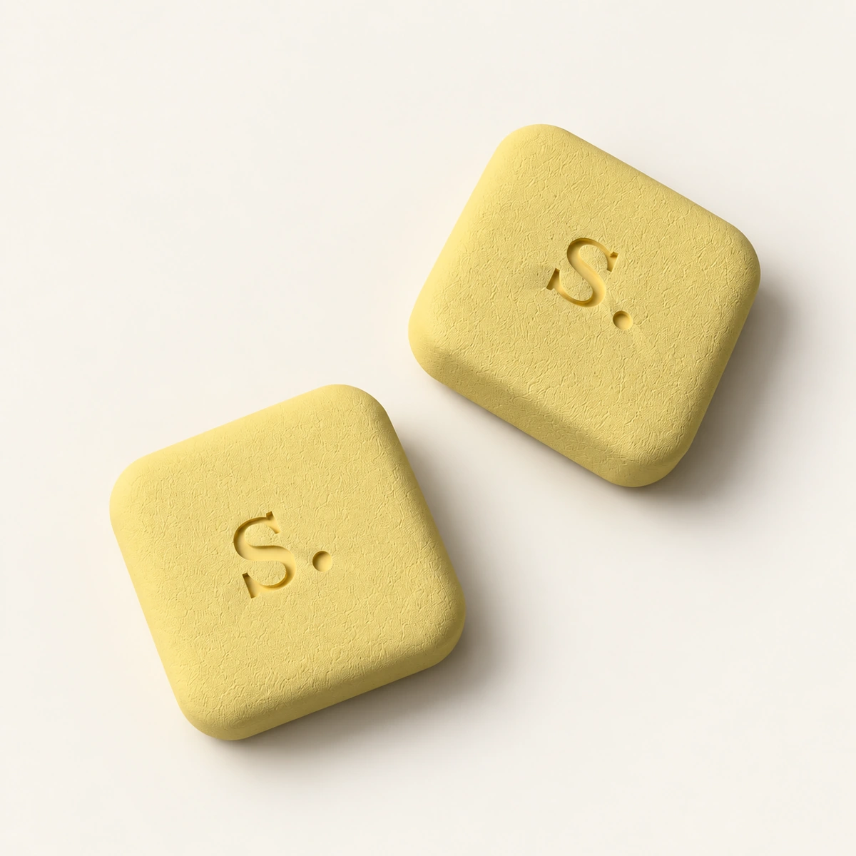 Signal-RX tadalafil 20 mg tablet visualization: two yellow tablets on a cream tabletop.